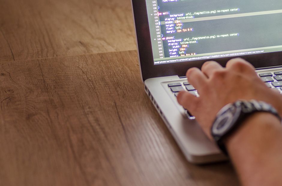Developer coding on a laptop while structuring Claude Skills to reduce token usage