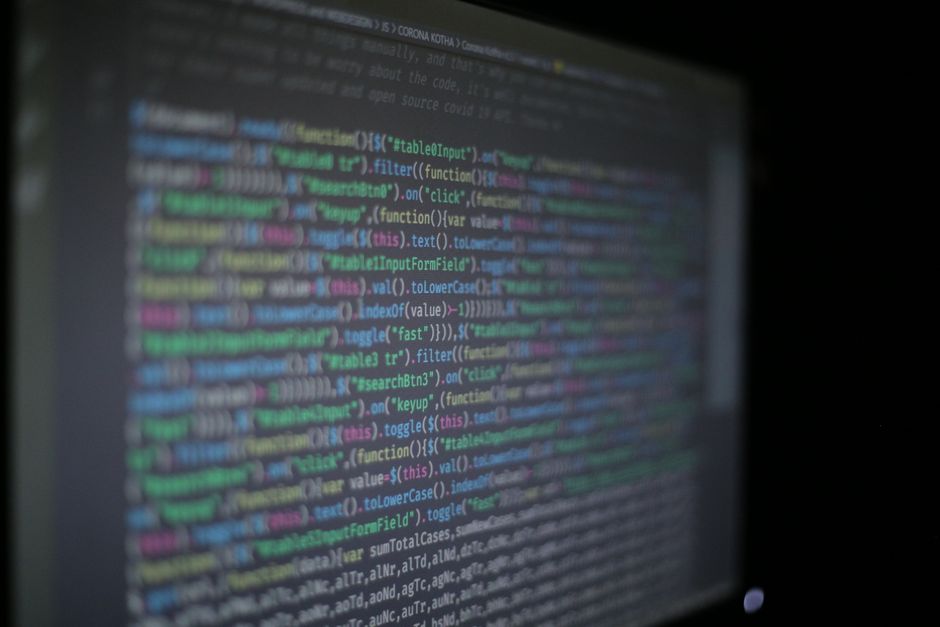 Colorful programming code on a monitor illustrating ways to reduce token usage in Claude Code