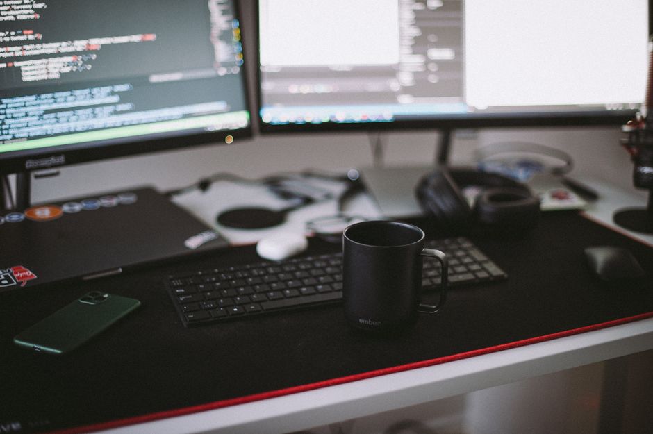 Dual-monitor developer workspace representing reducing token usage in Windsurf